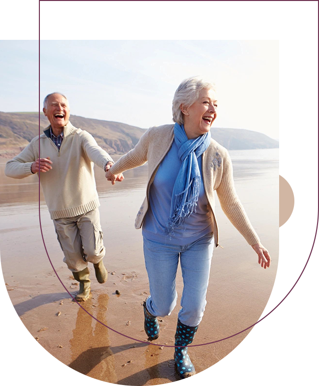 A man and woman are running on the beach.