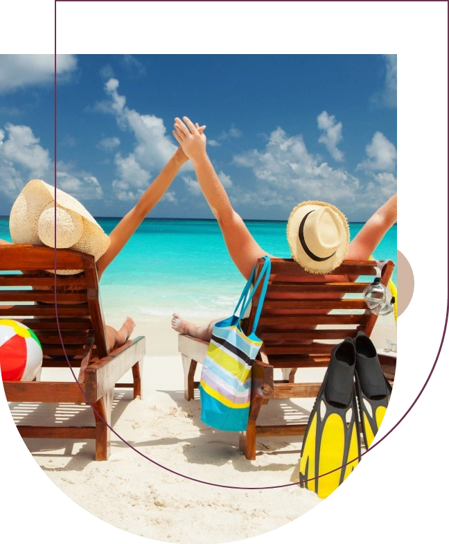 Two people sitting on a beach chair with their arms up.