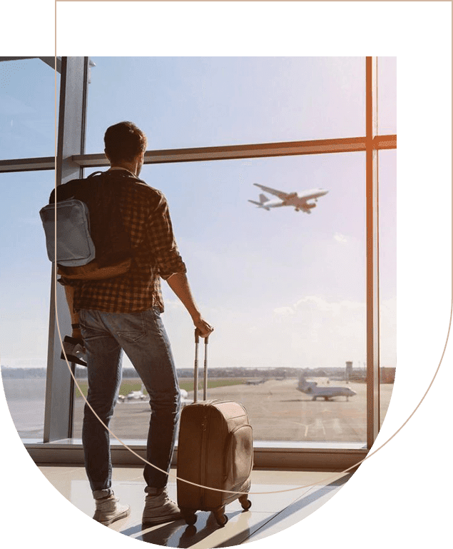 A man standing in front of an airport window.