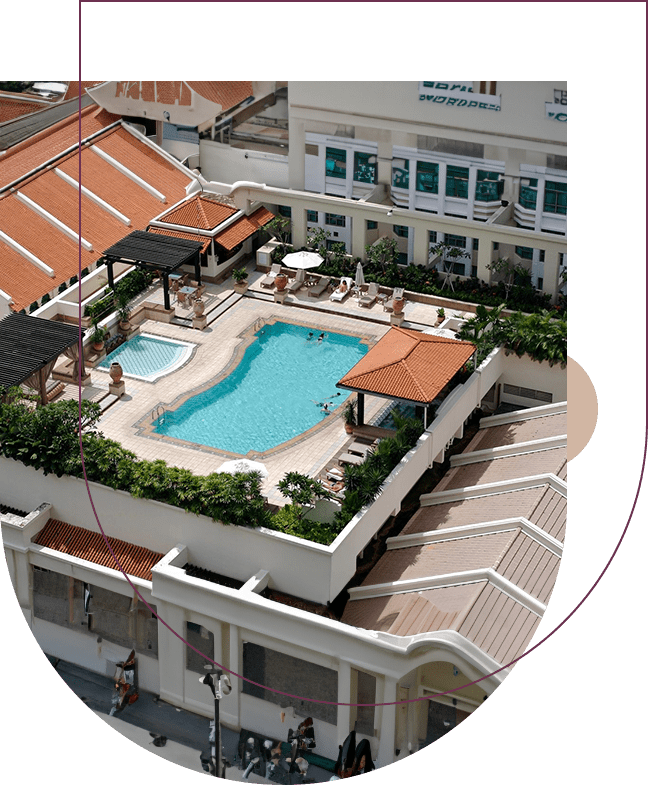 A pool with an umbrella and some chairs